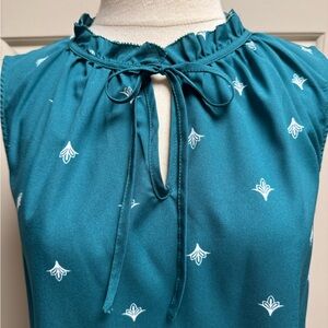 Teal Sleeveless Self Tie-Neck Blouse with Ruffles and White Floral Motif